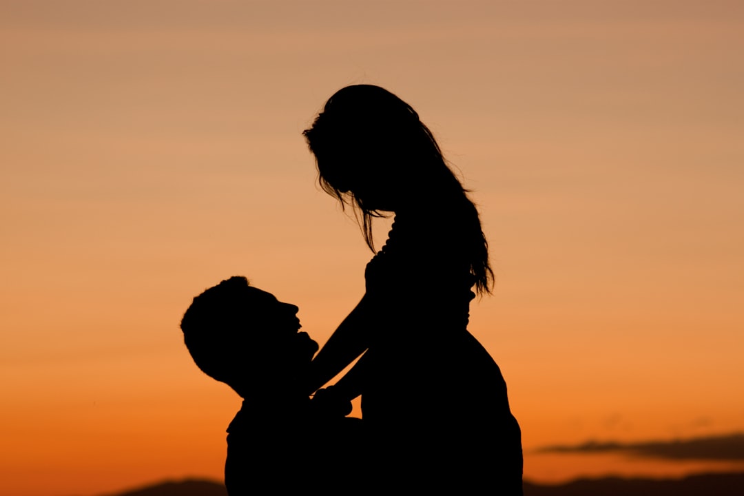 silhouette of man carrying the woman photography