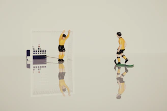 Animated soccer player figurines competing on a vibrant miniature football field.