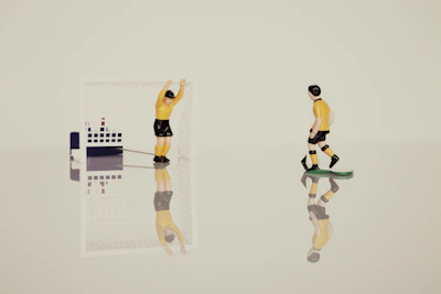 Animated soccer player figurines competing on a vibrant miniature football field.