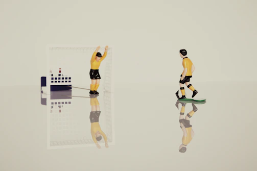 Miniature soccer players in mid-action with animated effects on a lively field.