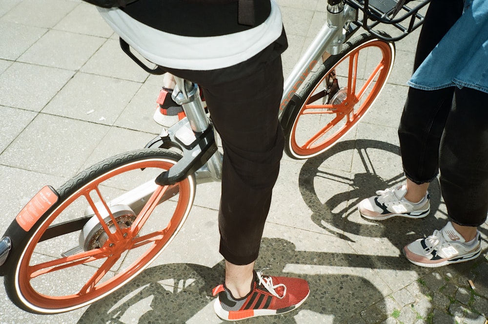 person wearing black pants riding gray bicycle