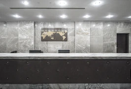 A welcoming spa reception desk with soft lighting and fresh flowers.