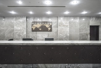 A welcoming office reception area with the be,global logo on the wall and a world map highlighting 150+ countries.