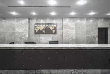A friendly staff member assisting guests at a reception desk.