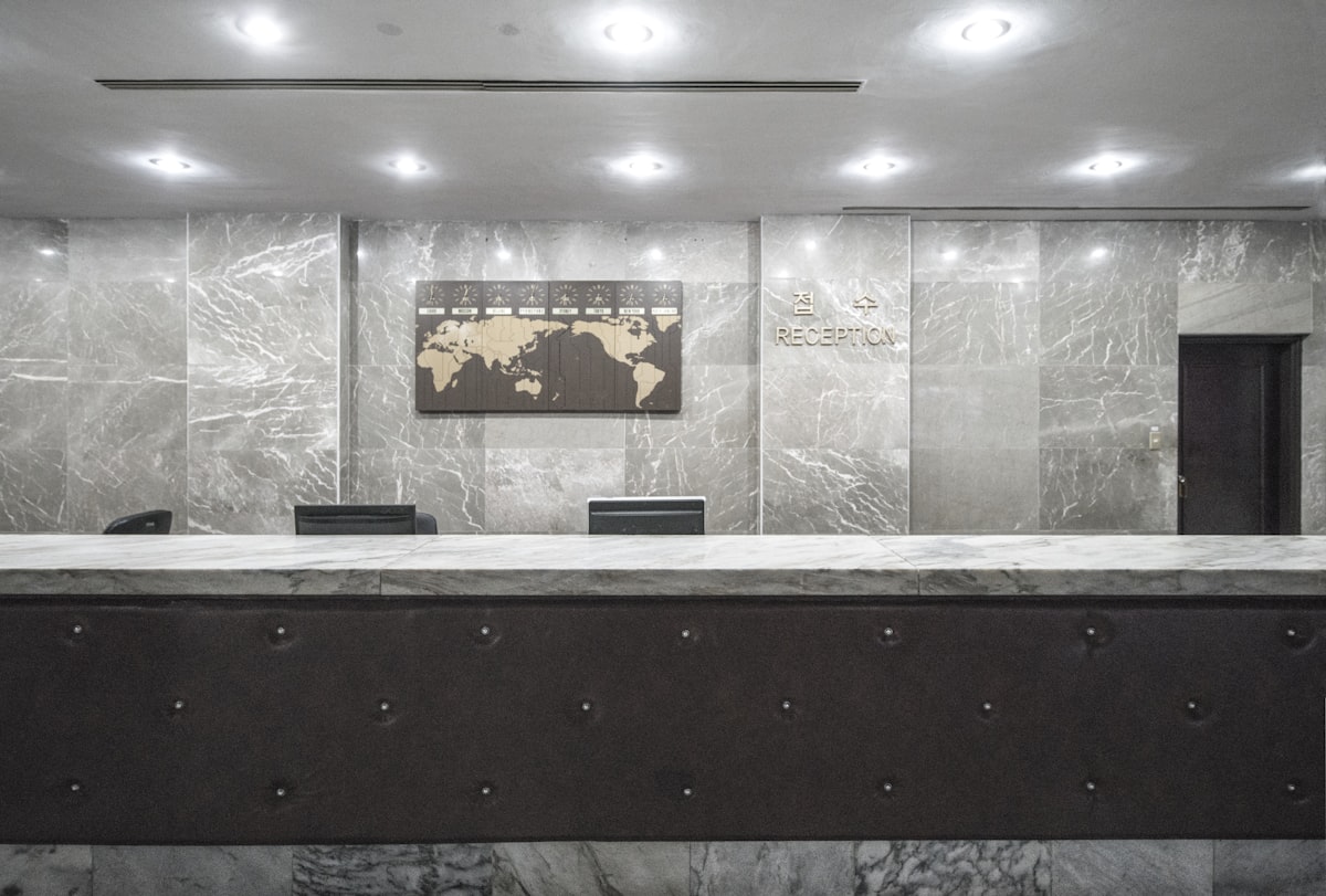 Modern hotel reception desk with wood paneling