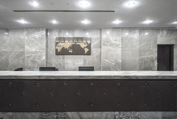 Modern hotel reception desk with wood paneling