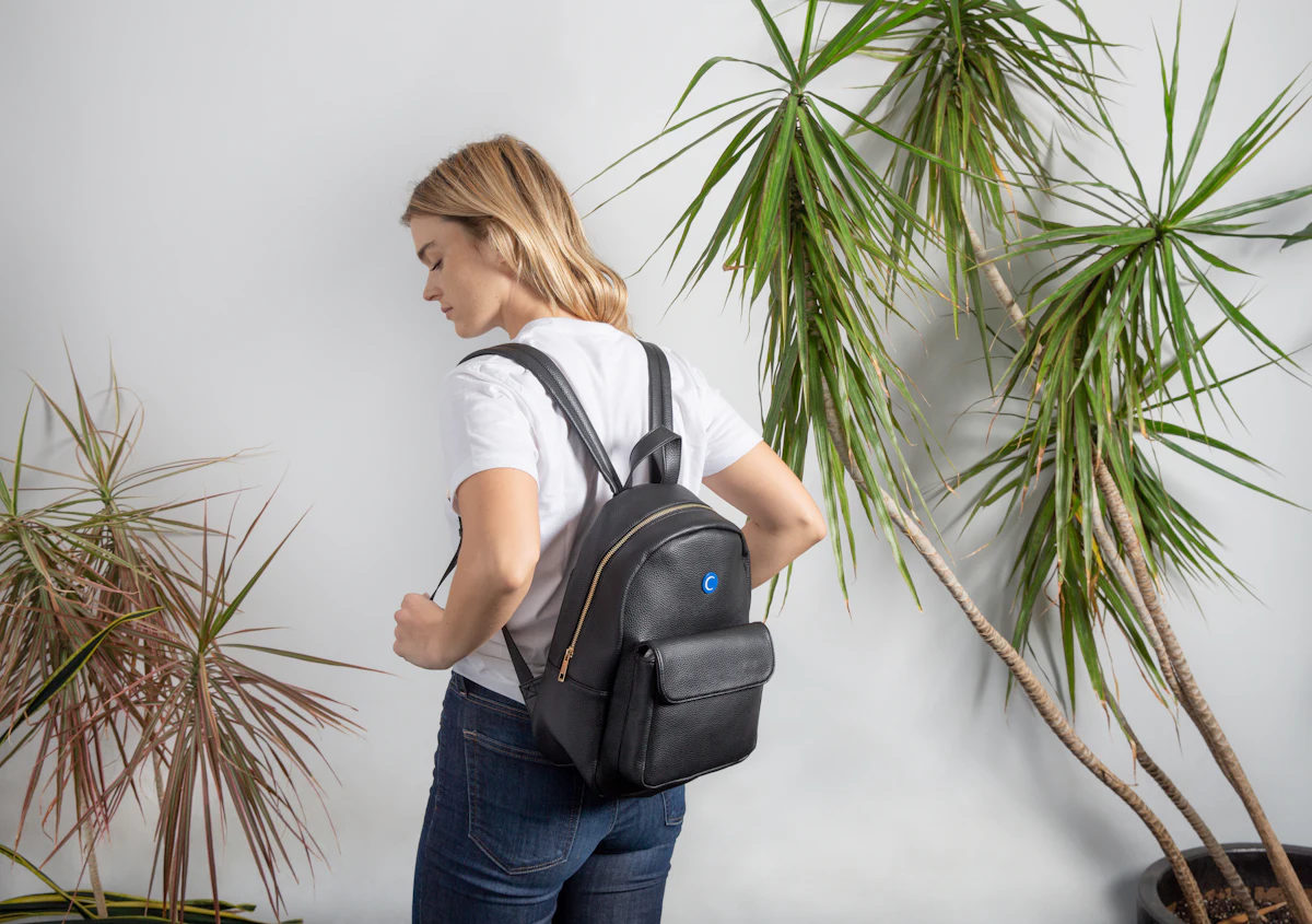 A young student wearing a black backpack