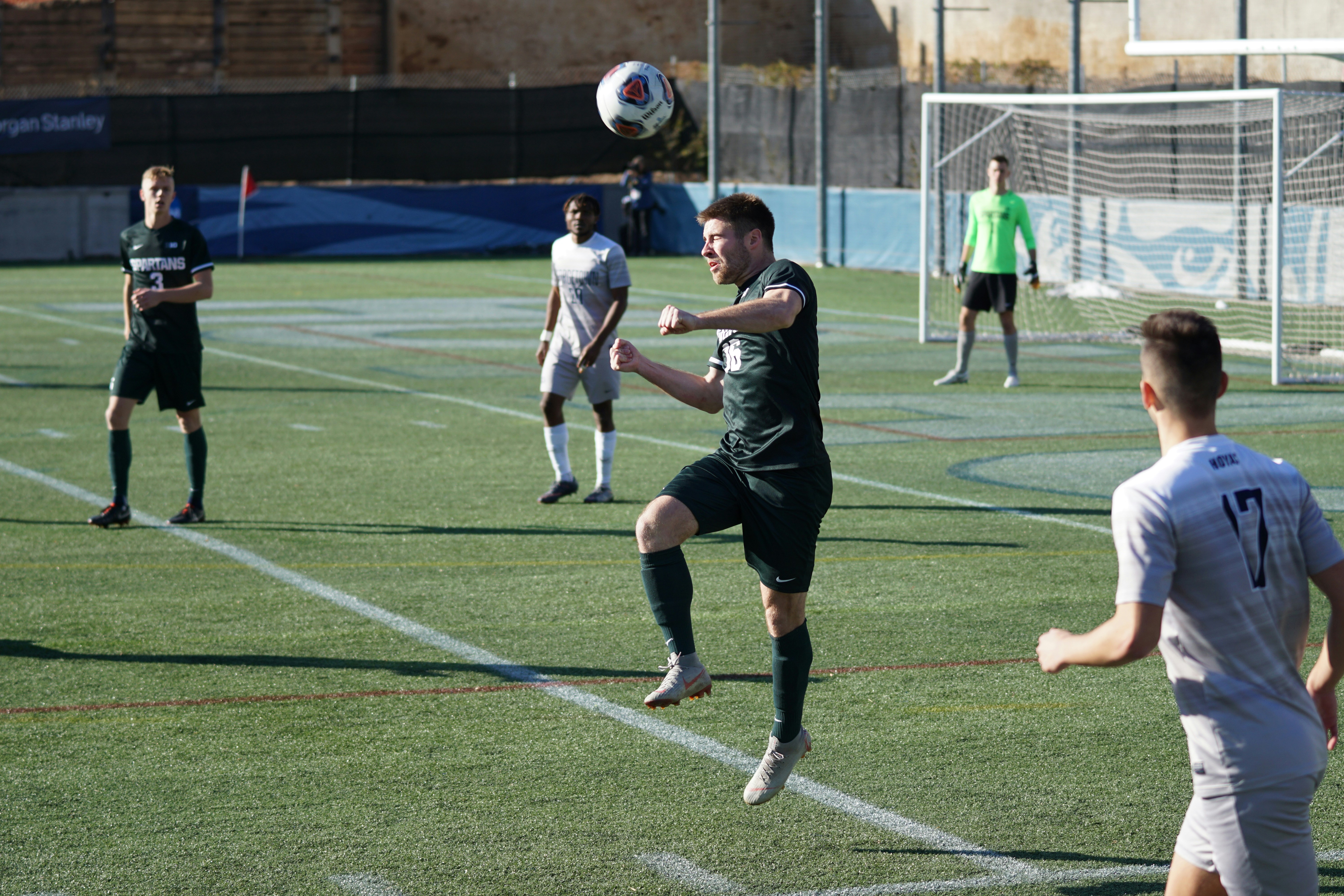 group of people playing soccer during daytime