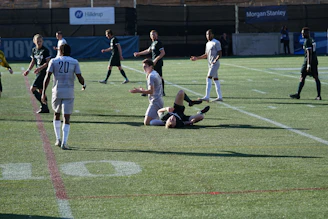 Medical team attending to an injured player on a soccer field during a match.