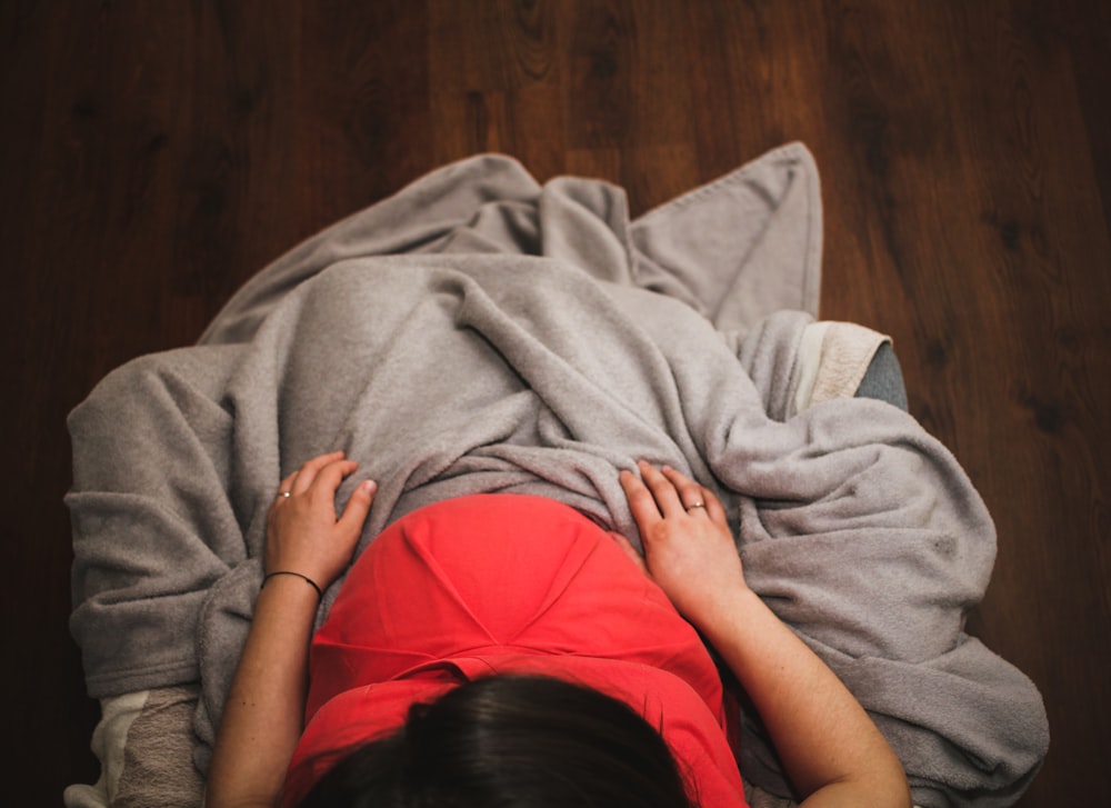 woman covering herself in gray blanket