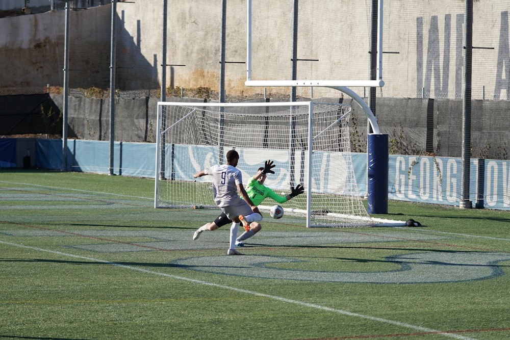 soccer player kicking the ball on the field