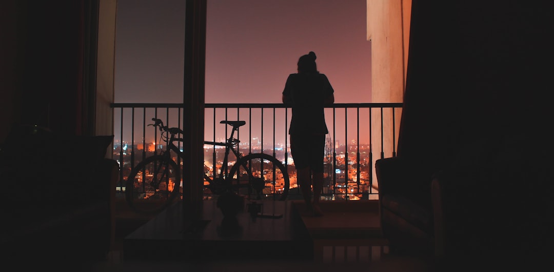 silhouette of person beside the bicycle
