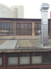 A panoramic view of a high-rise building in Dubai with visible HVAC ducting installations.