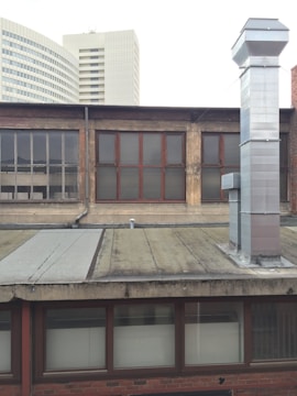 A panoramic view of a high-rise building in Dubai with visible HVAC ducting installations.