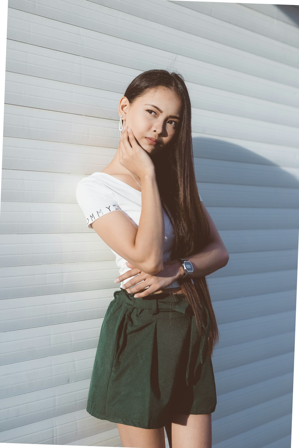 woman standing beside white wall