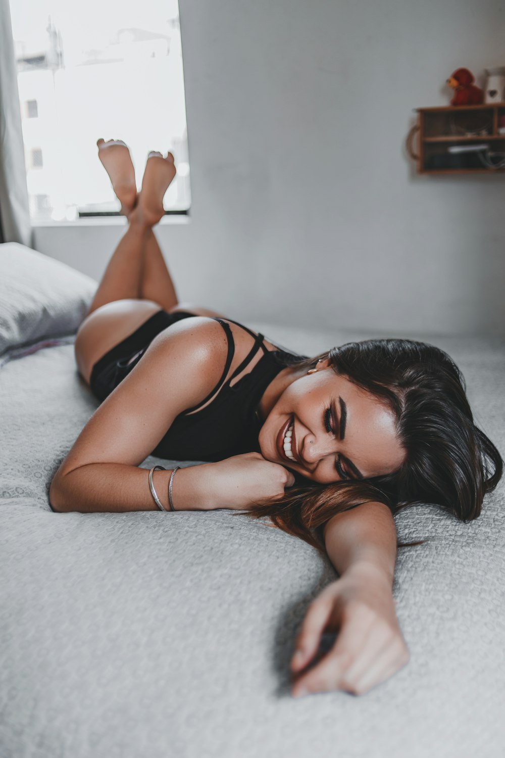smiling woman lying on the bed