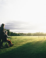 woman standing next to woman riding wheelchair