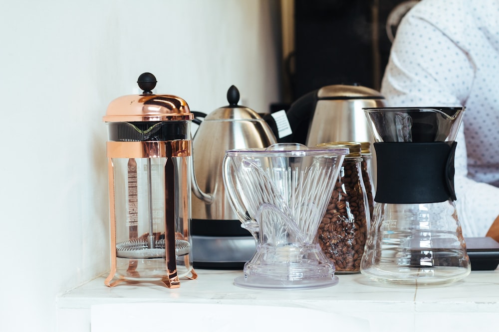 four coffee pots on white desk