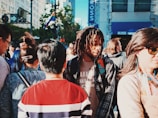 A diverse group of people wearing trendy outfits in an urban setting.