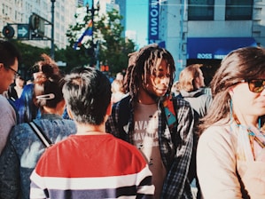 A diverse group of people wearing stylish, casual outfits in a vibrant urban setting.