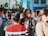 A vibrant city street scene showcasing people wearing modern urban fashion.