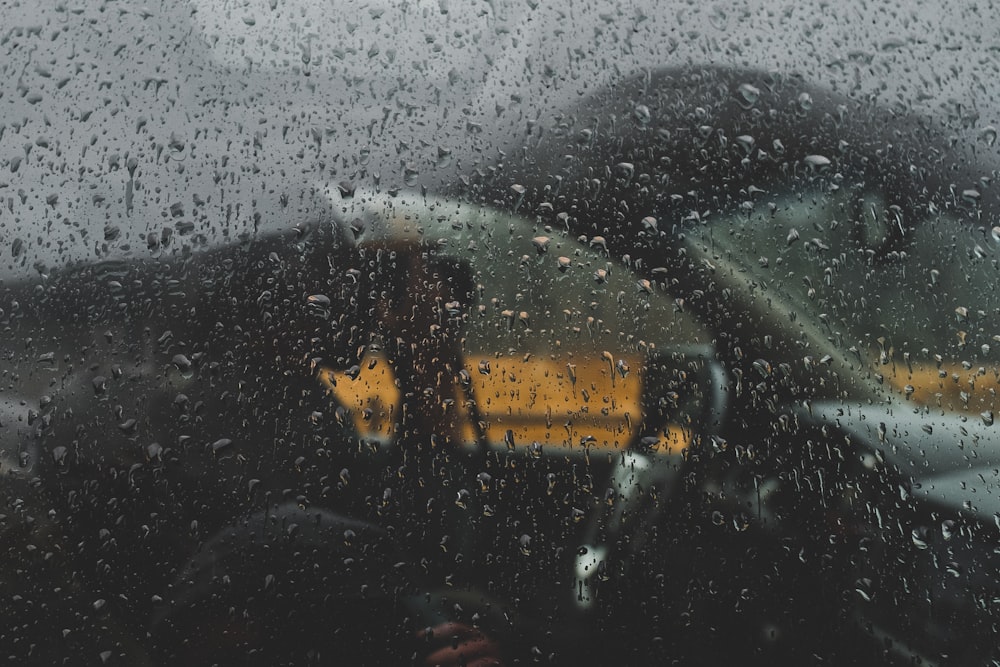 man in side vehicle during rainy daytime