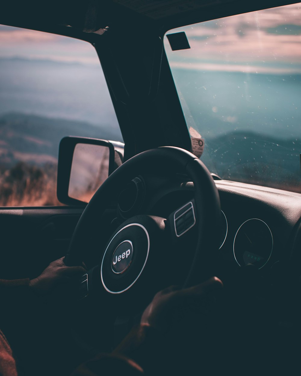 person holding Jeep steering wheel