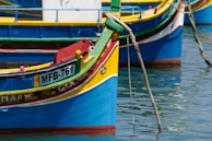 Colorful boats floating on calm waters in a Lombok fishing village.