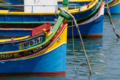 Colorful fishing boats bobbing in the clear waters of Marsaxlokk harbor.