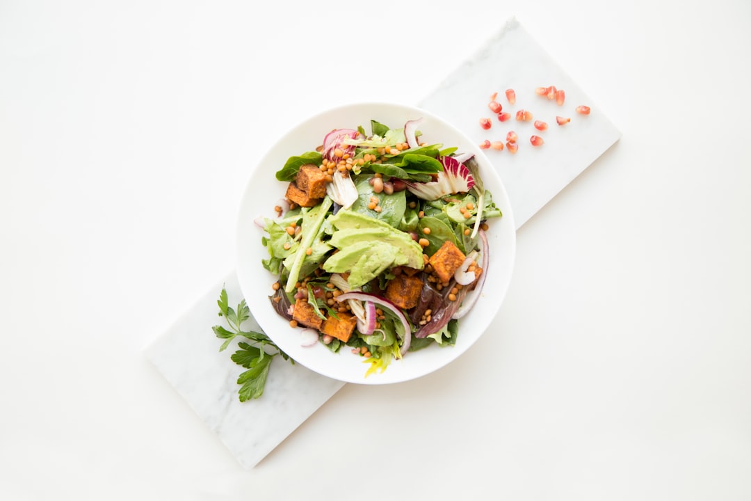 cooked food with sliced vegetables in white bowl,