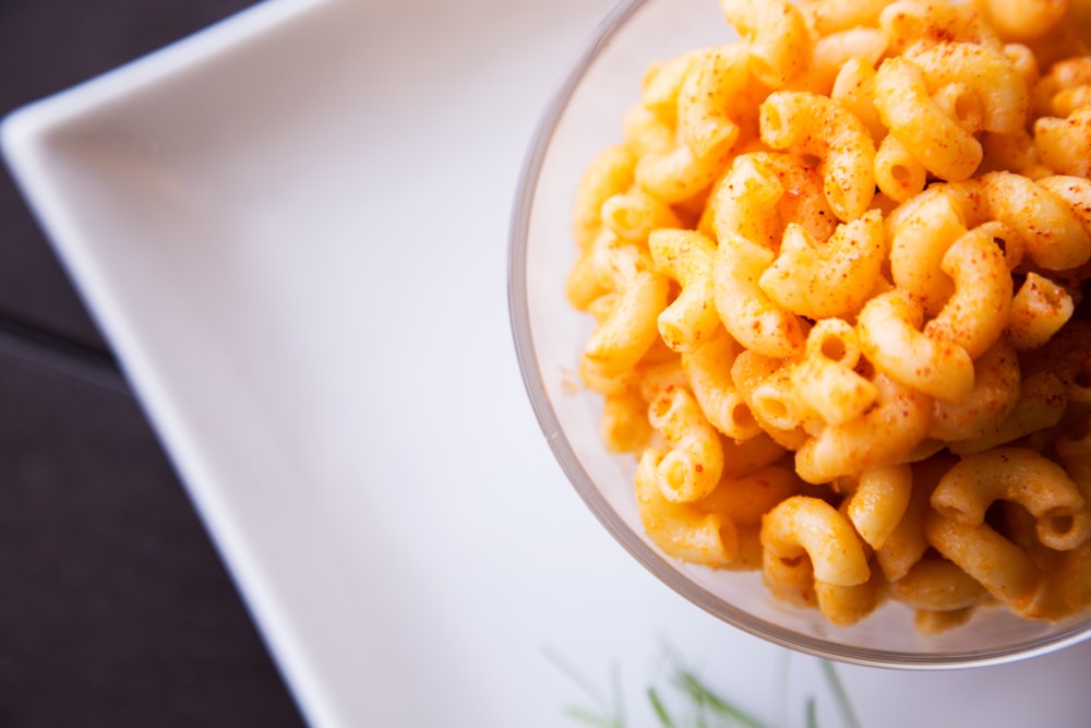 yellow pasta on clear glass bowl