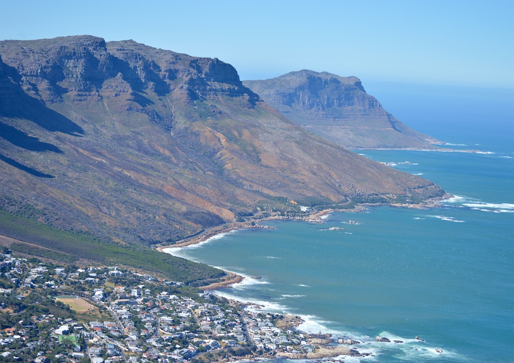 mountain beside sea during daytime