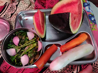 A colorful and nutritious school lunch tray with fresh vegetables and balanced portions.