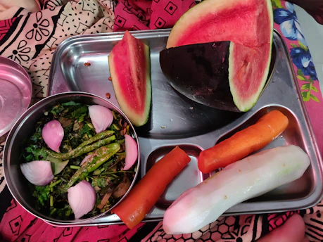 A colorful and nutritious school lunch tray with fresh vegetables and balanced portions.