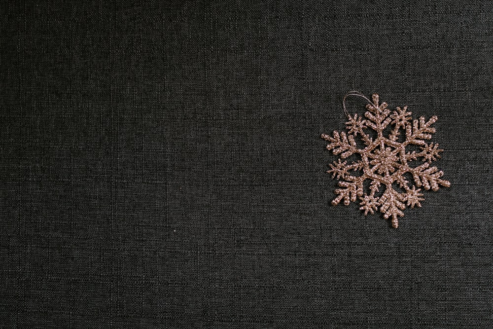 brown snowflake patch on black textile