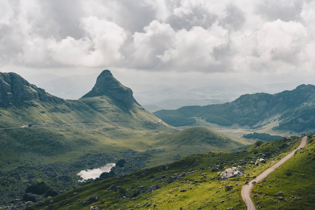 green mountains under white clouds