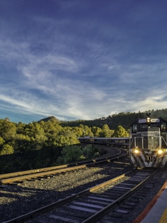 black train with light on during daytime
