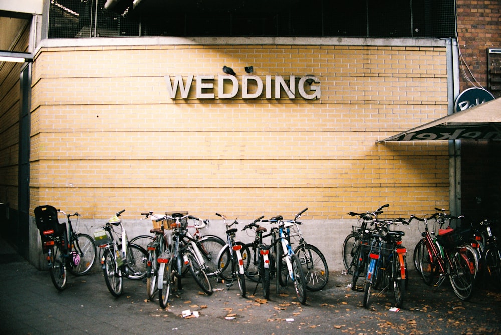 bicycles parked near Wedding signage