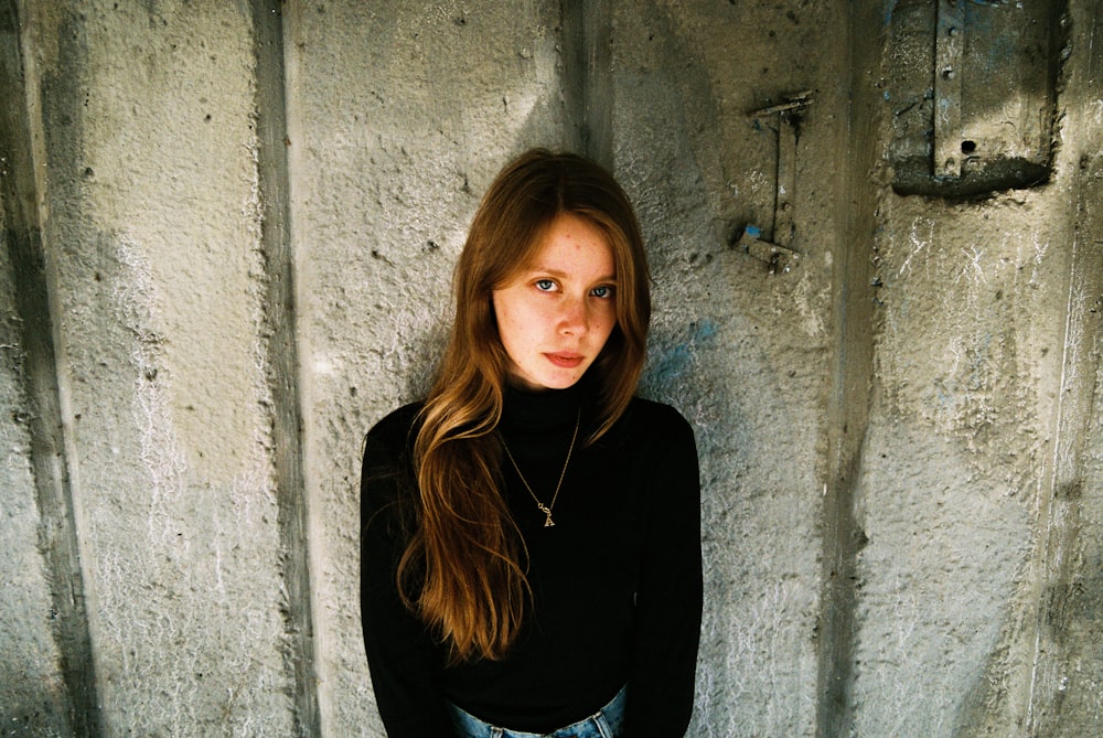 woman standing near concrete wall