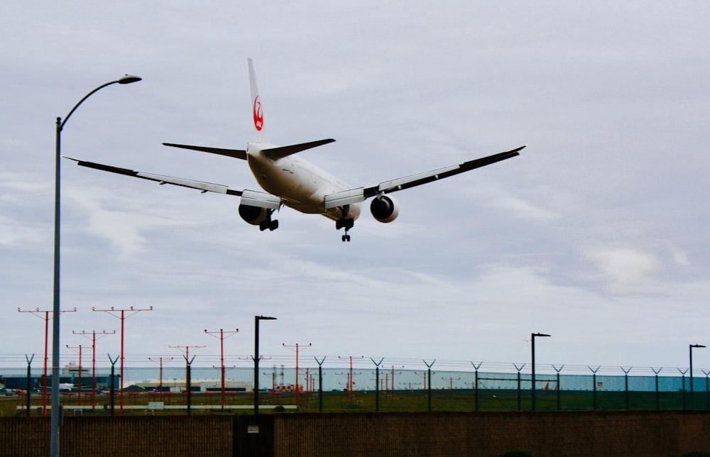 white airplane flying on the sky