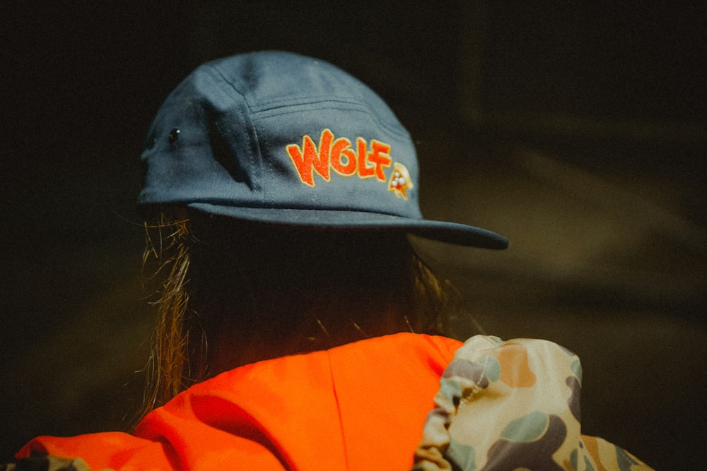 woman wearing blue Wolf fitted cap