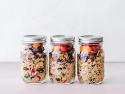 three full clear glass jars with lids