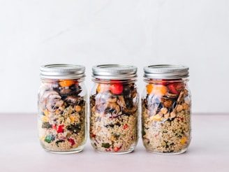 three full clear glass jars with lids
