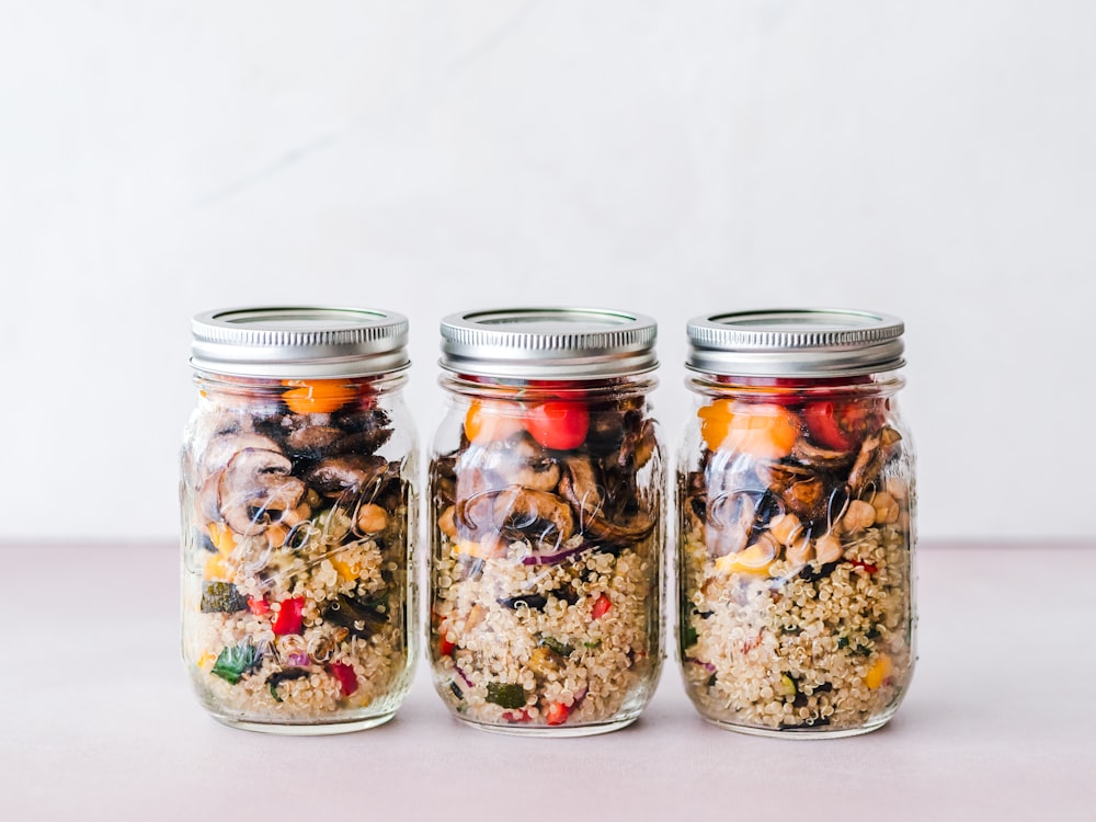 three full clear glass jars with lids