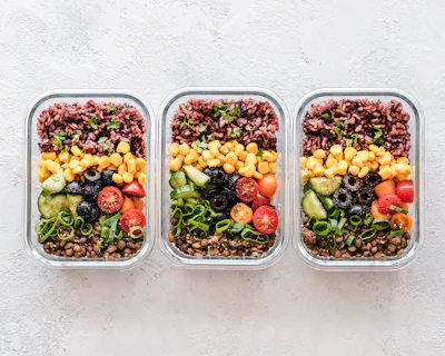 A close-up of colorful mixed salads in clear containers.