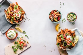 cooked dishes on plates and bowls