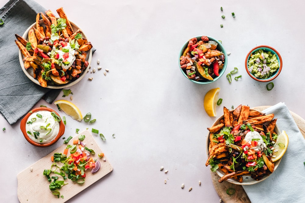 cooked dishes on plates and bowls