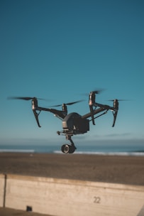 black quadcopter drone flying