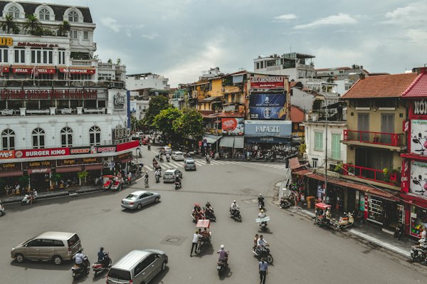 Cars and motorcycles on road during daytime — Hanoi, Vietnam