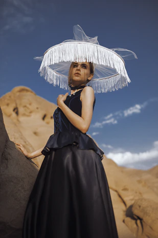 An elegant desert-themed clothing set in rich fabrics displayed on a mannequin against a dark cosmic gradient backdrop.